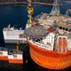 Illustration for article titled Here's The Largest Oil Rig Ever On Top Of The Largest Transport Ship